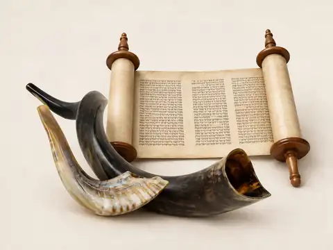 Shofars arranged with an open Torah scroll